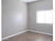 Simple bedroom with hardwood floors and a large window, offering natural light at 34214 W Sahuaro St, Tonopah, AZ 85354