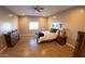 Bright bedroom with wood flooring and a queen-size bed at 34214 W Sahuaro St, Tonopah, AZ 85354