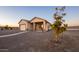 Tan one-story house with attached garage and covered porch at 34214 W Sahuaro St, Tonopah, AZ 85354