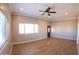 Bright living room with wood-look tile floors and ceiling fan at 34214 W Sahuaro St, Tonopah, AZ 85354