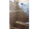 Large walk-in shower with tile surround and built-in seat at 34214 W Sahuaro St, Tonopah, AZ 85354