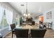 Glass dining table with leather chairs, view into living room at 3448 W Sunshine Butte Dr, San Tan Valley, AZ 85144