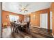 Dining room with wood table and chairs, orange walls, hardwood floor at 3448 W Sunshine Butte Dr, San Tan Valley, AZ 85144