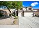 Two-story house with a large driveway and landscaped yard at 3448 W Sunshine Butte Dr, San Tan Valley, AZ 85144