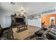 Spacious living room featuring leather sofas and a large TV at 3448 W Sunshine Butte Dr, San Tan Valley, AZ 85144