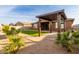 Backyard with covered patio, artificial grass, and landscaping at 35350 W Marin Ave, Maricopa, AZ 85138