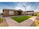 Covered patio and artificial turf in a well-maintained backyard at 35350 W Marin Ave, Maricopa, AZ 85138