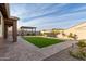 Landscaped backyard with covered patio and artificial turf at 35350 W Marin Ave, Maricopa, AZ 85138