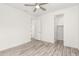 Bright bedroom with ceiling fan, window, and wood-look floors at 35350 W Marin Ave, Maricopa, AZ 85138