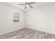 Bright bedroom with wood-look floors and window shutters at 35350 W Marin Ave, Maricopa, AZ 85138