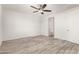 Spacious bedroom with ceiling fan and access to bathroom at 35350 W Marin Ave, Maricopa, AZ 85138