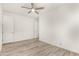 Bright bedroom with ceiling fan and wood-look floors at 35350 W Marin Ave, Maricopa, AZ 85138