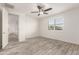 Bright bedroom with wood-look floors and sliding door to closet at 35350 W Marin Ave, Maricopa, AZ 85138