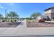 Ocotillo Park entrance featuring walking paths, playground and modern architectural detailing under a bright blue sky at 35350 W Marin Ave, Maricopa, AZ 85138