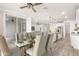 Modern dining area with glass table and chairs, open to kitchen at 35350 W Marin Ave, Maricopa, AZ 85138