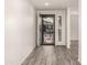 Inviting entryway with stylish iron door and wood-look floors at 35350 W Marin Ave, Maricopa, AZ 85138