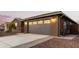 View of the garage and exterior of the house at dusk at 35350 W Marin Ave, Maricopa, AZ 85138