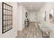 Bright hallway featuring a bench, mirror, and wood-look floors at 35350 W Marin Ave, Maricopa, AZ 85138