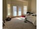 Main bedroom with carpet, large window and double doors at 355 E 13Th Ave, Apache Junction, AZ 85119