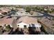 Aerial view of single-story home with solar panels and a covered patio at 3677 N Hudson Dr, Florence, AZ 85132