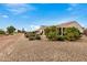 View of backyard, showing a gravel area, and some landscaping at 3677 N Hudson Dr, Florence, AZ 85132