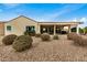 Home's back exterior, featuring a covered patio and landscaping at 3677 N Hudson Dr, Florence, AZ 85132