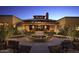 Elegant community clubhouse with a landscaped courtyard and benches at night at 3677 N Hudson Dr, Florence, AZ 85132