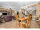 Bright dining room featuring a wood table and chairs, hardwood floors, and access to the backyard at 3677 N Hudson Dr, Florence, AZ 85132