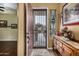 Front entry with wood console table, stained glass, and security door at 3677 N Hudson Dr, Florence, AZ 85132