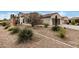 House exterior showcasing landscaping and a two-car garage at 3677 N Hudson Dr, Florence, AZ 85132