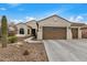 Single-story home with two-car garage and desert landscaping at 3677 N Hudson Dr, Florence, AZ 85132