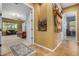 Well-lit hallway with access to bedrooms and a view of a bedroom with sitting area at 3677 N Hudson Dr, Florence, AZ 85132