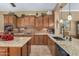 Modern kitchen with granite countertops, dark wood cabinets, and stainless steel appliances at 3677 N Hudson Dr, Florence, AZ 85132