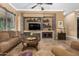 Living room with stone fireplace and built-in entertainment center at 3677 N Hudson Dr, Florence, AZ 85132