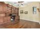 Home office with built-in wooden desk and shelving at 3677 N Hudson Dr, Florence, AZ 85132