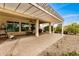 Extended covered patio with pergola, seating, and grill area at 3677 N Hudson Dr, Florence, AZ 85132