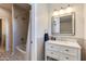 Modern bathroom with gray tile and white vanity at 3838 E Devonshire Ave, Phoenix, AZ 85018