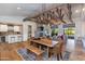 Open concept dining area with a large wooden table and access to the living room at 3838 E Devonshire Ave, Phoenix, AZ 85018