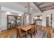 Rustic-chic dining room with a farmhouse table and exposed beams at 3838 E Devonshire Ave, Phoenix, AZ 85018