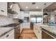 Large kitchen with white shaker cabinets, granite island, and farmhouse sink at 3838 E Devonshire Ave, Phoenix, AZ 85018