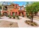 Two-story home with Spanish-style architecture, landscaping, and a walkway at 3935 E Rough Rider Rd # 1235, Phoenix, AZ 85050