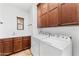 Bright laundry room with washer, dryer, and ample cabinet space at 3935 E Rough Rider Rd # 1235, Phoenix, AZ 85050