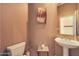 Clean bathroom with pedestal sink and toilet at 41019 N Congressional Dr, Anthem, AZ 85086