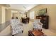 Formal dining room with seating for six and adjacent living room at 41019 N Congressional Dr, Anthem, AZ 85086