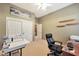 Home office features built-in shelving, sewing machine, and comfortable office chair at 41019 N Congressional Dr, Anthem, AZ 85086