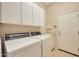 Laundry room with washer, dryer, and cabinets at 41019 N Congressional Dr, Anthem, AZ 85086