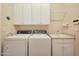 Laundry room with washer, dryer, and cabinets at 41019 N Congressional Dr, Anthem, AZ 85086