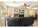 Relaxing living room featuring a fireplace and sectional sofa at 41019 N Congressional Dr, Anthem, AZ 85086