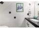 Charming half bathroom with black countertop and white tile at 4140 N 81St St, Scottsdale, AZ 85251