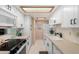 Modern galley kitchen with white cabinets and quartz countertops at 4140 N 81St St, Scottsdale, AZ 85251